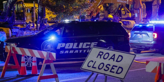 A police car parked at road closed sign close to the scene of a mass shooting in Lewiston, Maine