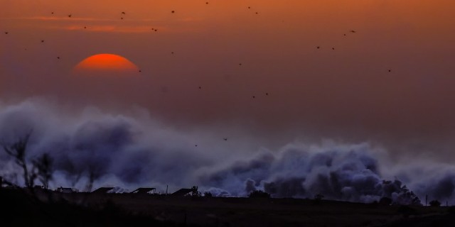 Smoke rises after Israeli shells strike the northern part of the Gaza Strip during sunset, 29 October 2023.