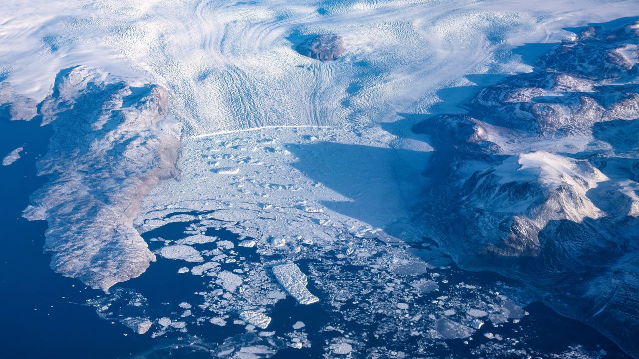 An aerial shot of a snowy coastline.