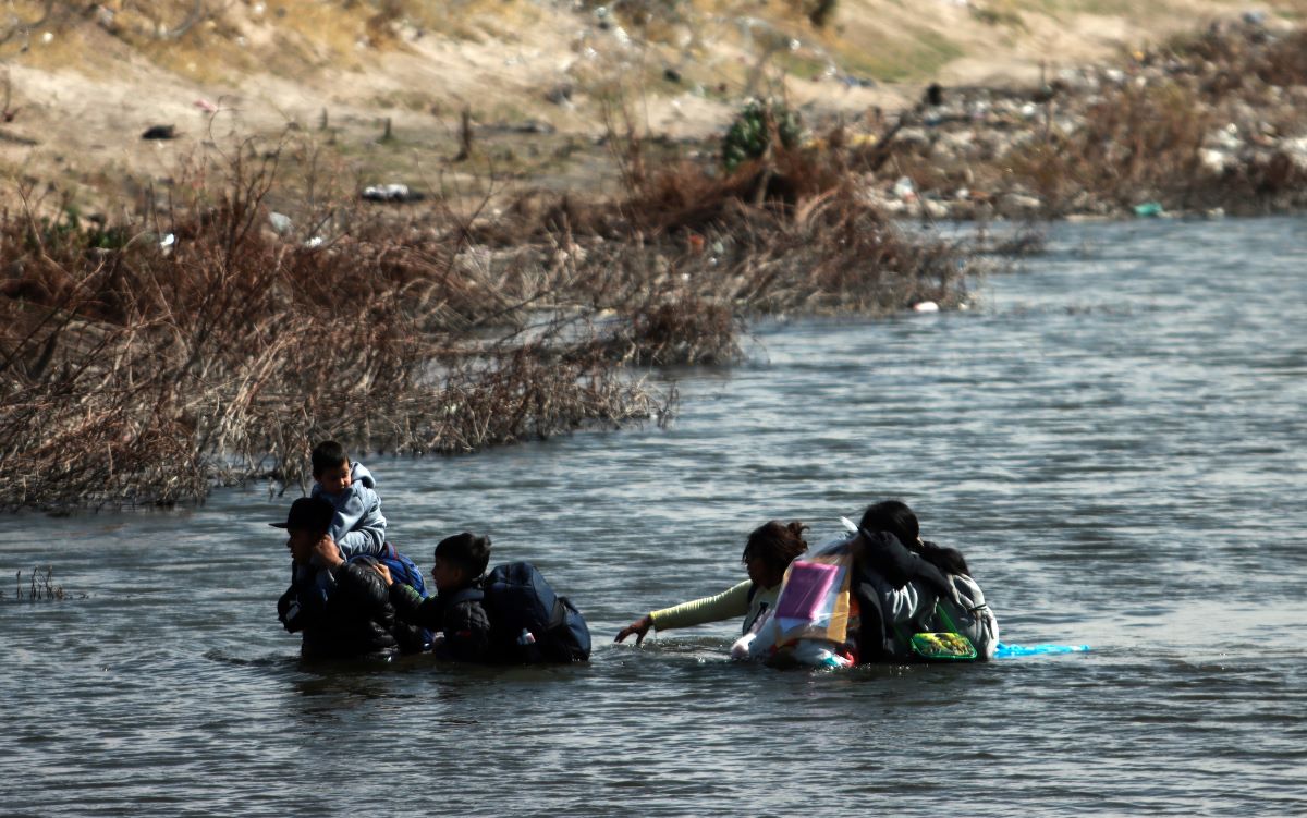 Migrants cross the Rio Grande