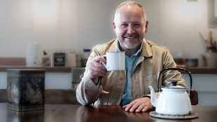 Presenter Mark Thompson holds a cup of tea