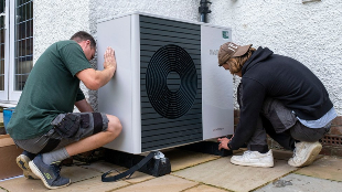 Air source heat pump experts install a heat pump unit into a 1930s-built house in Folkestone, Kent