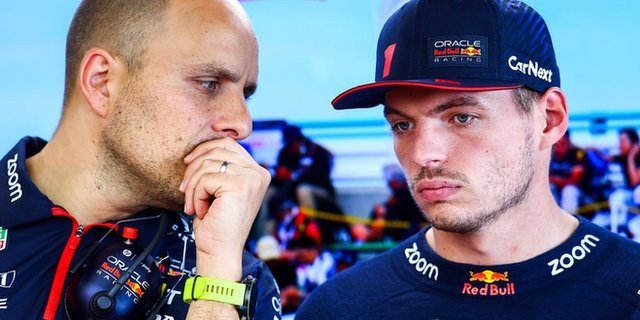 Gianpiero Lambiase and Max Verstappen having a conversation in the Red Bull garage at a Formula 1 race