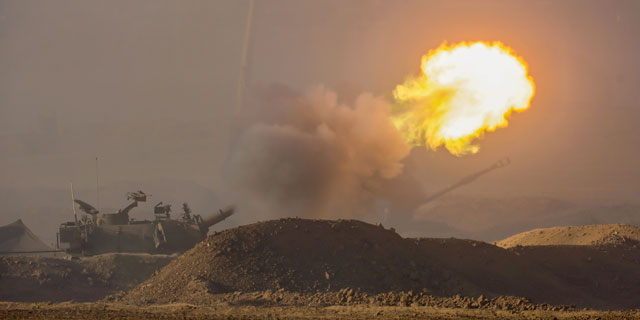 Israel Defense Forces soldiers fire a 155 mm howitzer at an undisclosed location near the border with Gaza, southern Israel, 31 October 2023