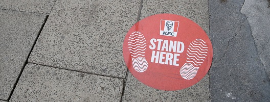 A social distancing pavement sticker outside a KFC restaurant