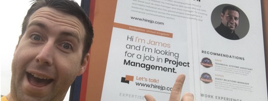 James Pemblington pointing to his CV on the back of a truck