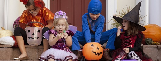 Children enjoying the spoils of trick or treat