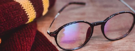 Harry Potter-style glasses and a burgundy scarf