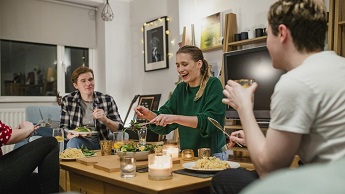 Generic image depicting people eating a meal in a home