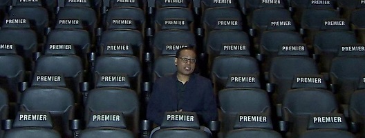 A man sitting in a cinema alone