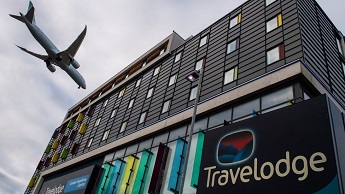 Stock image of a plane flying over a hotel