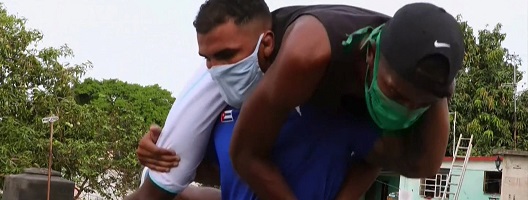 An athlete lifting his coach on his shoulders
