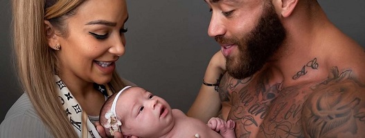 Safiyya Vorajee and Ashley Cain holding Azaylia