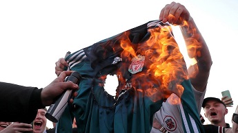 Fans burn a Liverpool replica shirt outside Elland Road against Liverpool's decision to be included in the European Super League