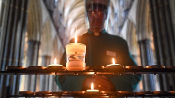 File image of the Very Reverend Nicholas Papadopulos, Dean of Salisbury, lighting a prayer candle inside Salisbury Cathedral on June 15, 2020