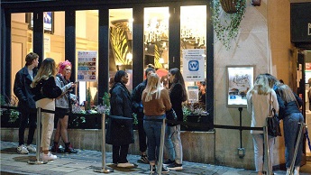 People queue at a pub in Birmingham, in between lockdowns