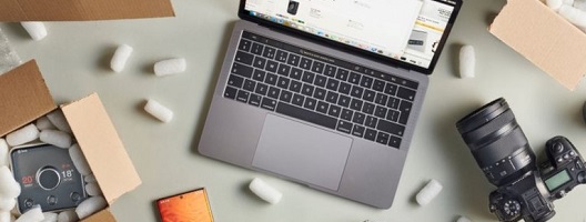 Illustrative image of a laptop surrounded by packaged goods