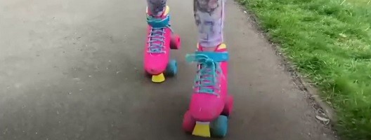 Someone's feet in bright pink rollerboots