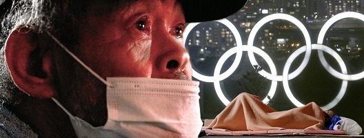 Homeless man in front of Olympic rings