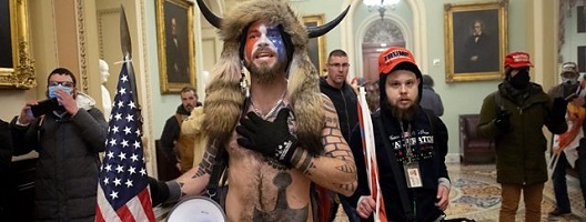 A pro-Trump mob confronts U.S. Capitol police outside the Senate chamber in Washington DC (Getty Images)
