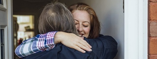 Generic image of people hugging on a doorstep