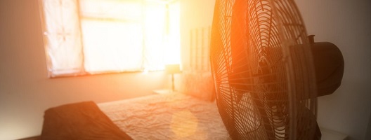 Generic image of a fan in a bedroom with sun shining through the window
