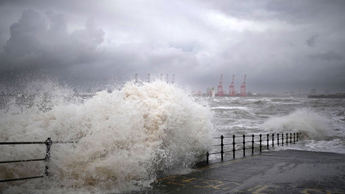 Waves crash on New Brighton promenade, on the Wirral