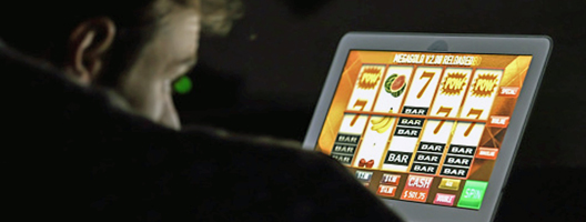 Generic image of man playing on a fruit machine