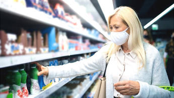 A woman wearing a face mask while shopping 