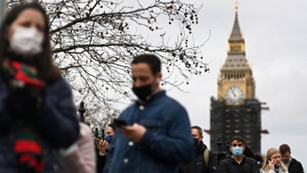 People wearing face masks outside the Palace of Westminster