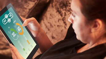 Generic image of a woman reading a smart meter on a tablet computer