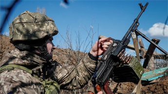 A Ukrainian serviceman holds a machine gun at a town in Donetsk, one of two breakaway regions