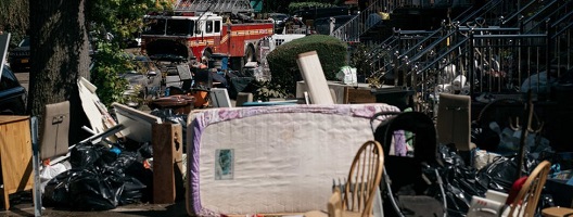 Damaged and destroyed items in the street after a night of heavy rain and wind caused many homes to flood in New York's Flushing neighbourhood