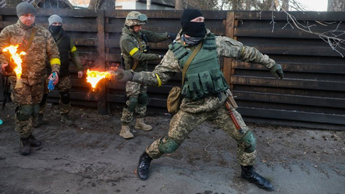 A member of the Ukrainian Territorial Defence Forces trains to throw Molotov cocktails in Kyiv