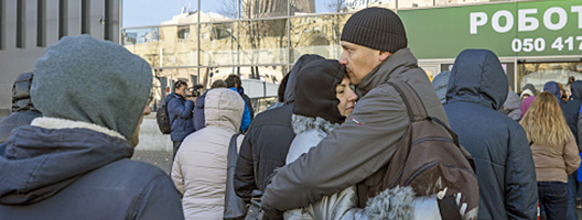 People embrace on the streets of Kyiv