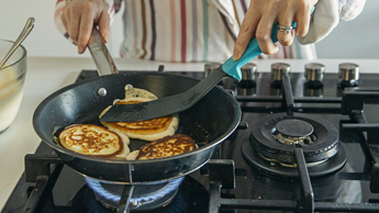 Generic image of someone cooking pancakes on a gas hob