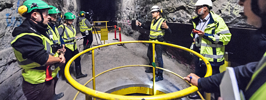 A media party examines a demonstration tunnel at Finland's Onkalo nuclear fuel repository