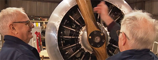 Two men work on the propellor of the World War One Sopwith Strutter