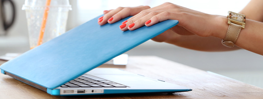 A woman closing a laptop