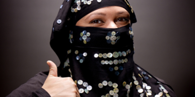 A woman poses in the 'pearly burka'  created by Modern Cockney Festival founders Saif Osmani and Andy Green