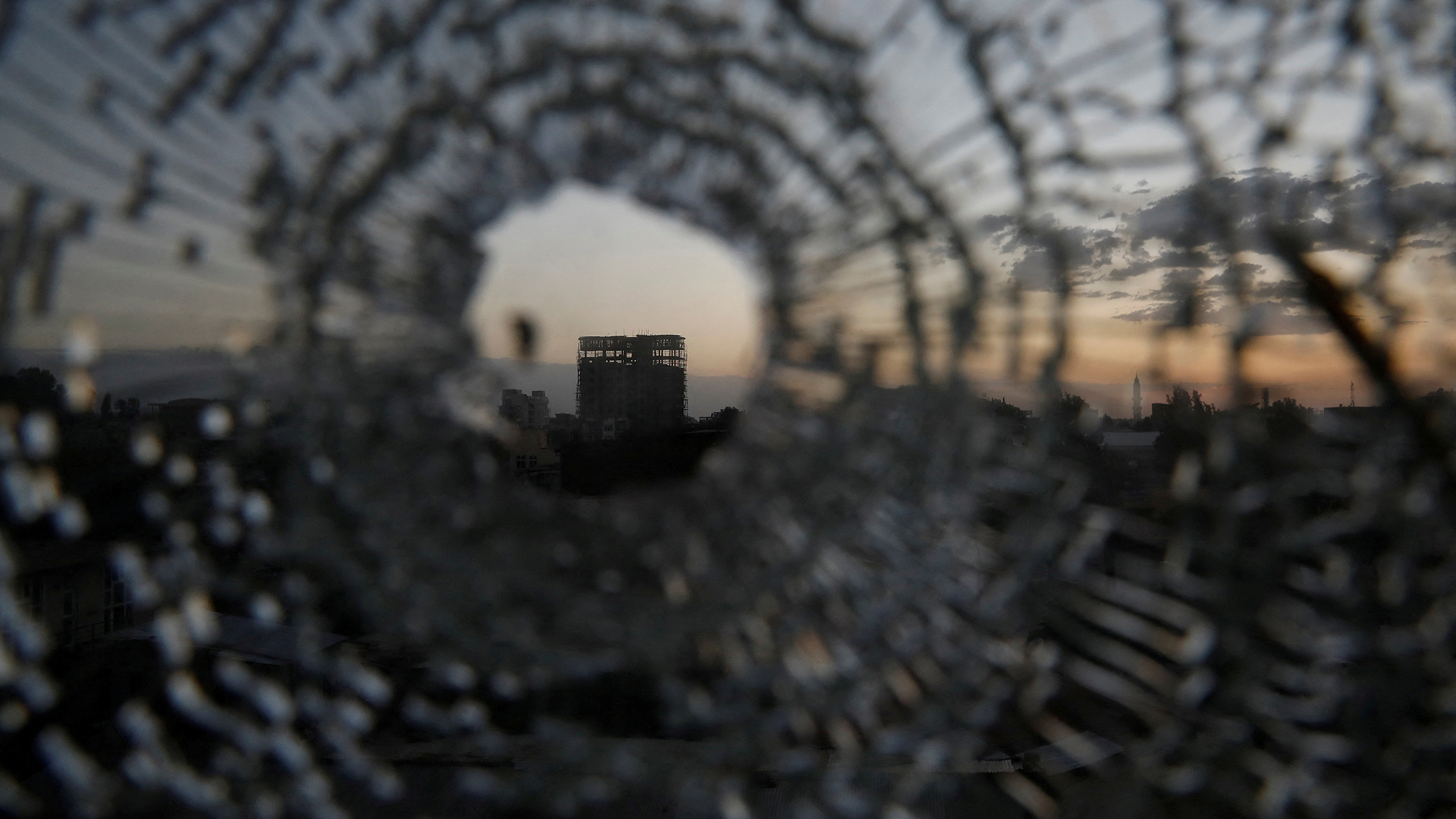 A building is seen through a bullet hole in a window of the Africa Hotel in the town of Shire, Tigray region, Ethiopia, March 16, 2021 (Credit: Baz Ratner/Reuters)